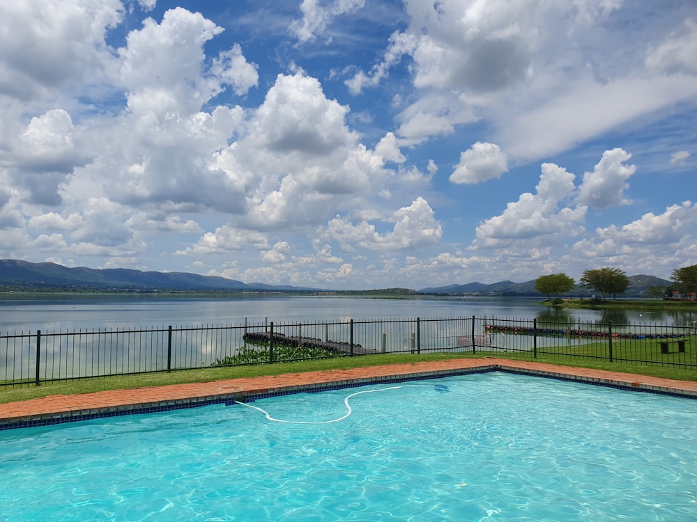 a large swimming pool next to a fenced in area