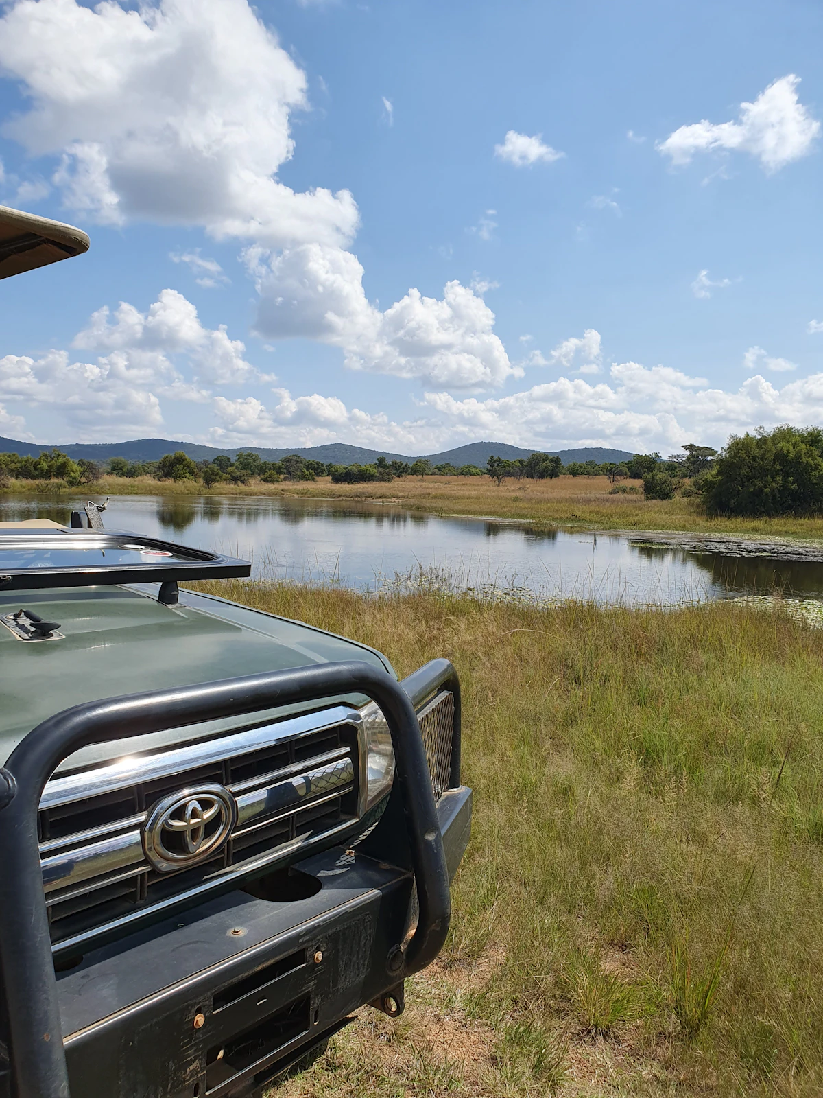 The vehicle parked at a private waterhole, no other engine for miles