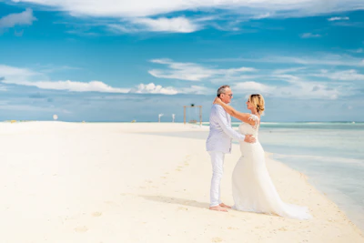 A joyful wedding couple exchanging vows on a serene Mauritius beach at sunset.