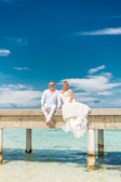 Couple dining elegantly on a cruise ship balcony overlooking the ocean