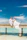 A romantic couple celebrating an engagement on a sleek yacht with turquoise waters surrounding them.