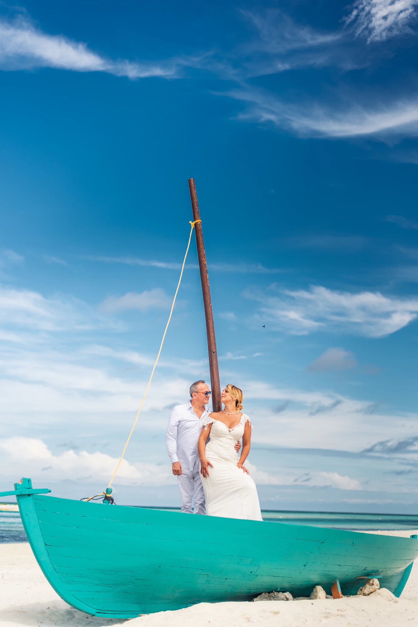 Wedding couple together on a sandy tropical beach by the sea