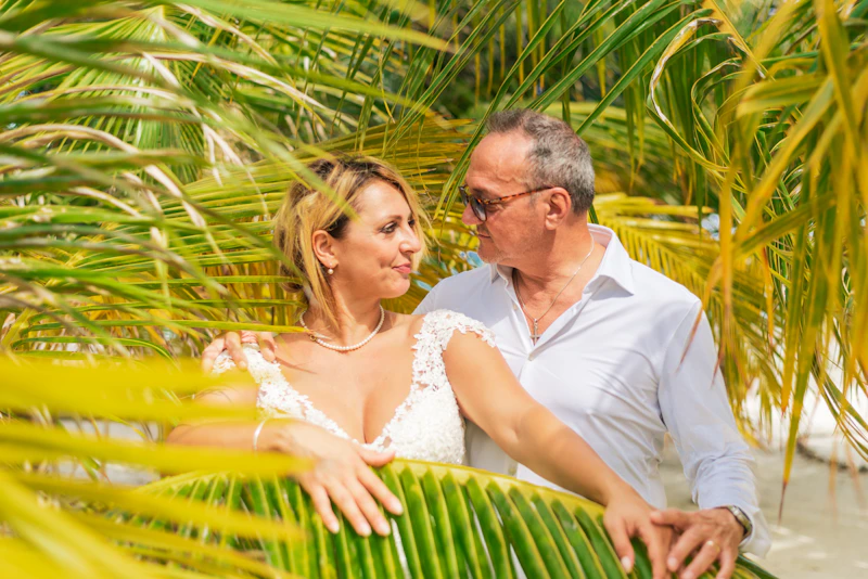 mature couple enjoying sunshine under palm trees
