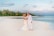 A serene couple enjoying a romantic moment on their honeymoon at a beautiful beach.