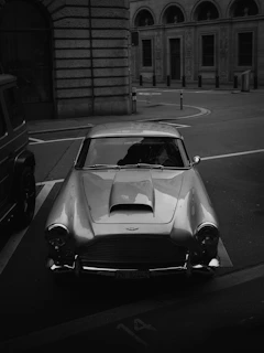 Classic vintage imported car with shiny paint and elegant curves in a city street