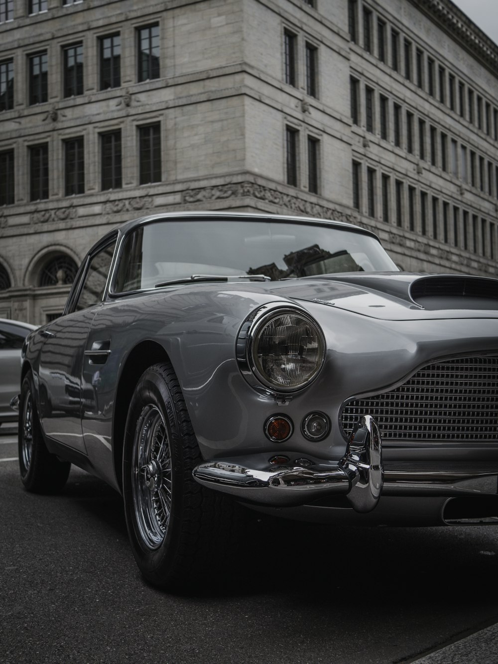 a silver sports car parked on the side of the road