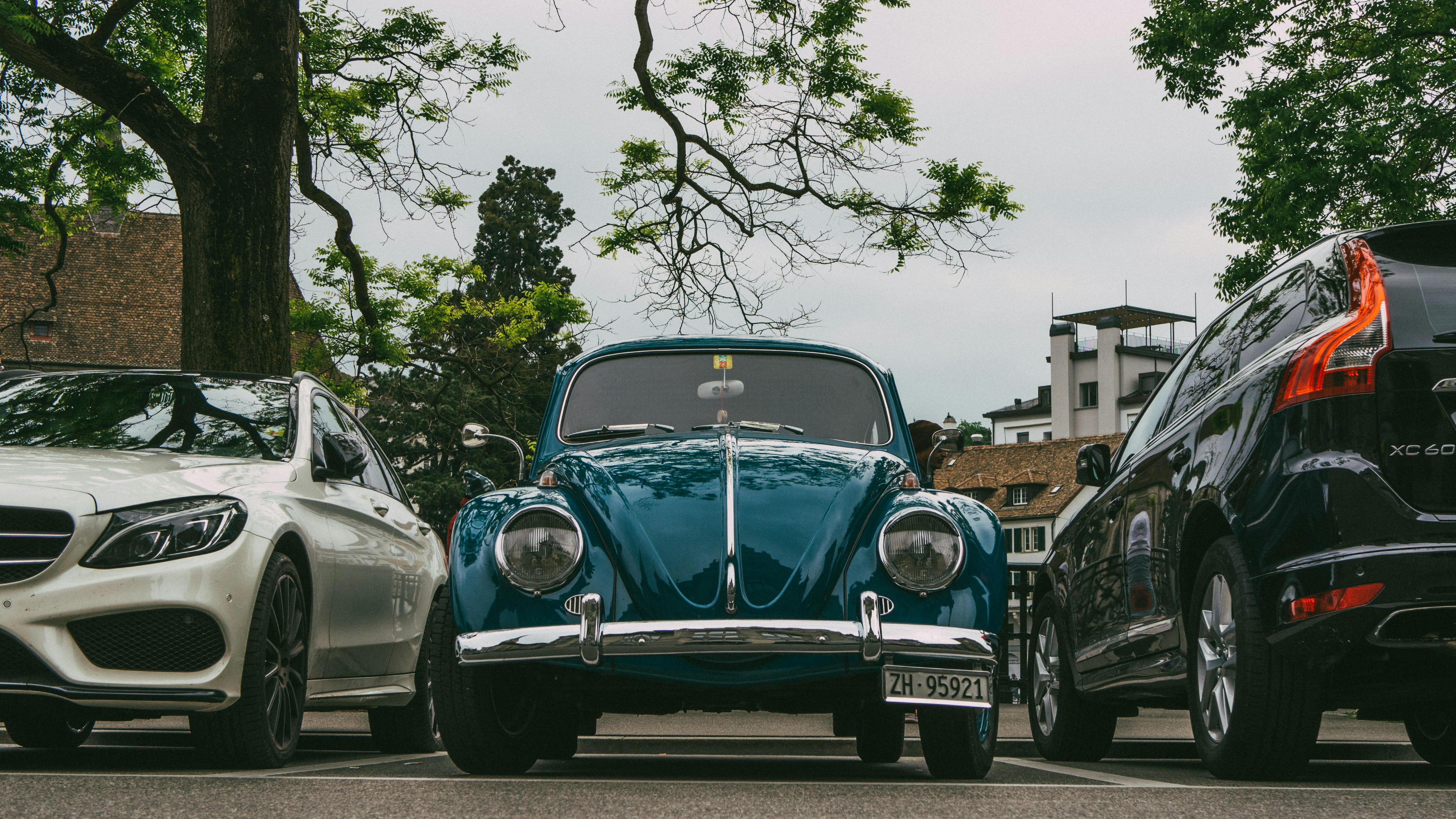 two cars parked next to each other in a parking lot