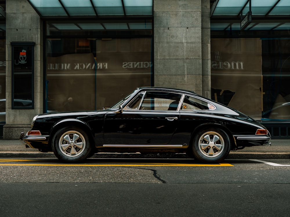 a black car parked on the side of the road