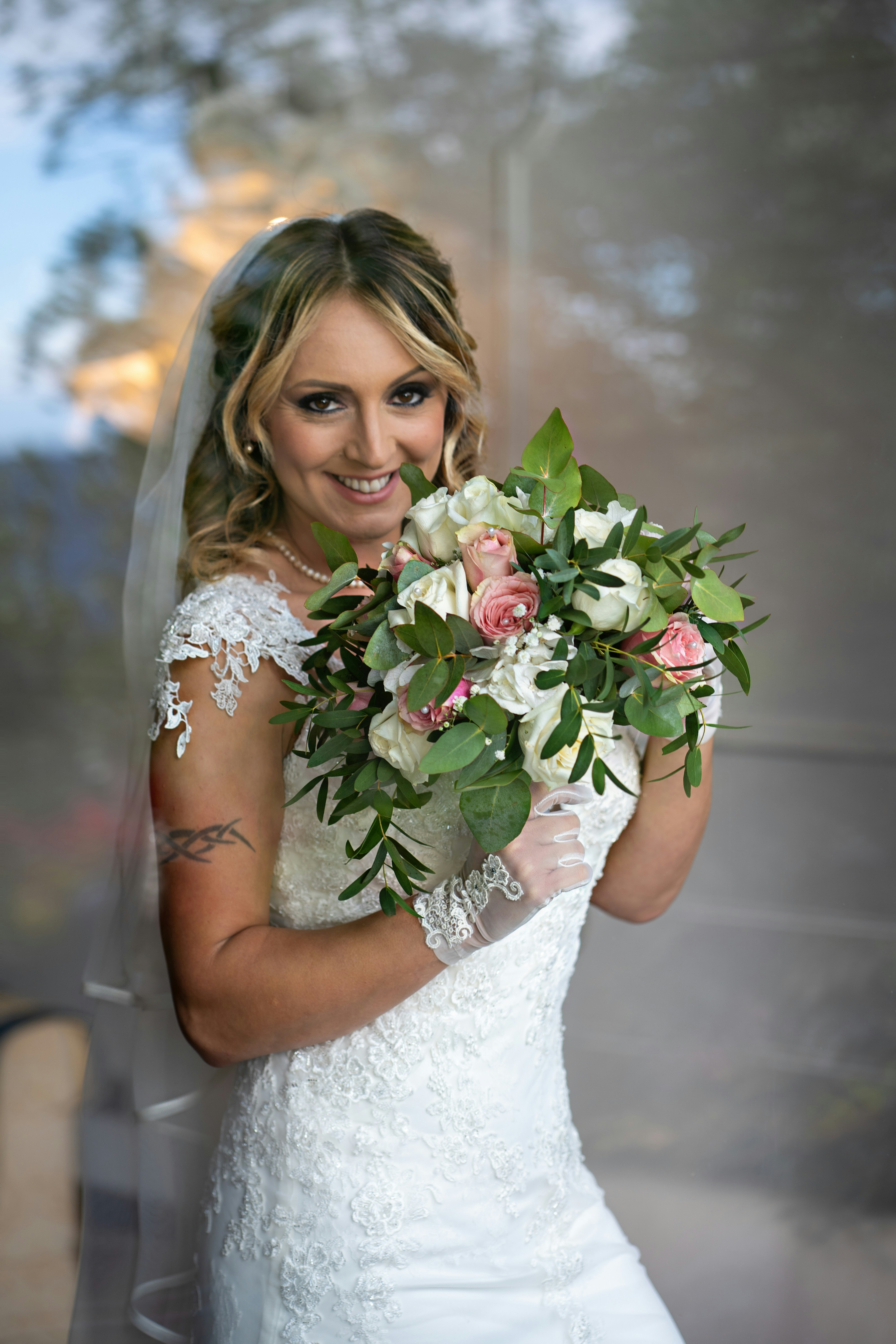 a woman in a wedding dress holding a bouquet of flowers