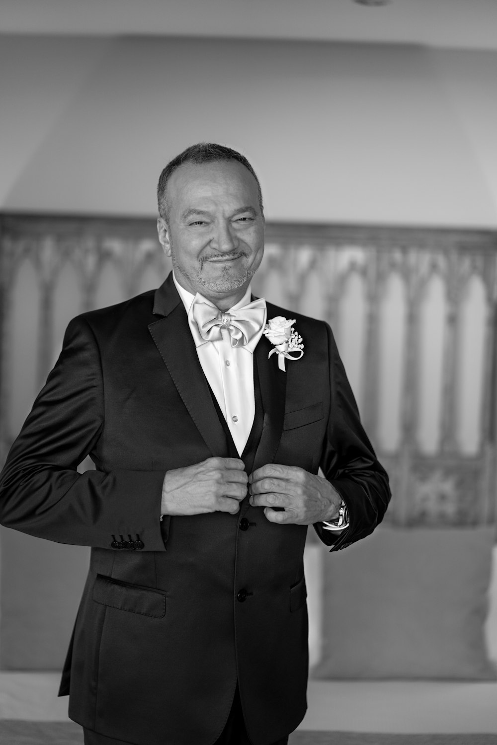 a black and white photo of a man in a tuxedo