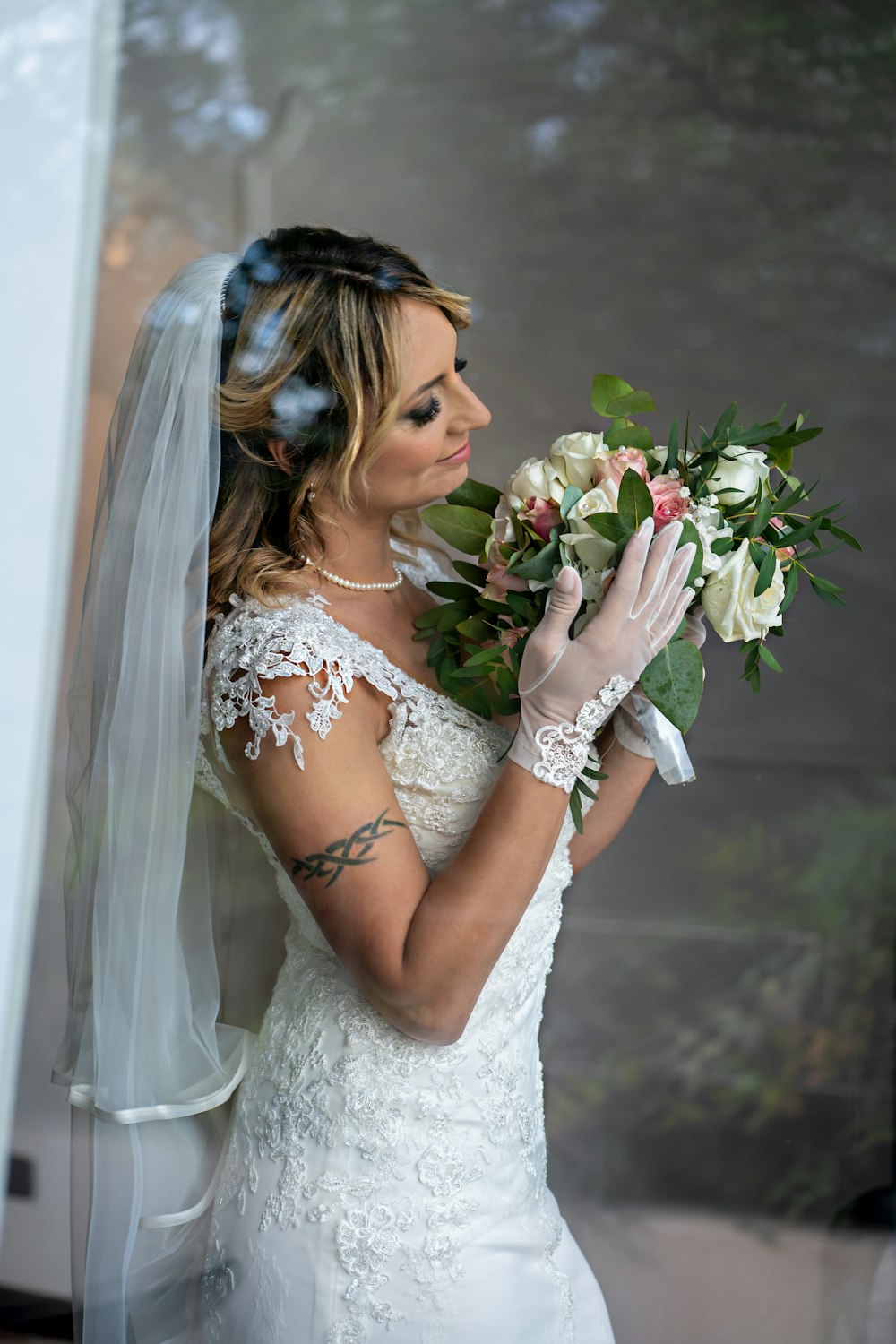 a woman in a wedding dress holding a bouquet of flowers