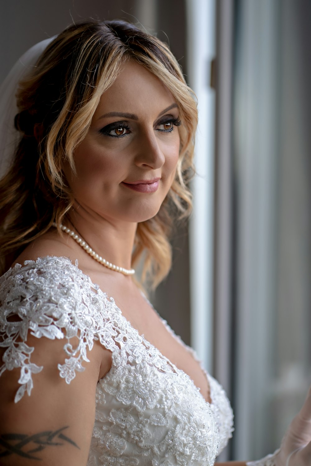 a woman in a wedding dress is smiling