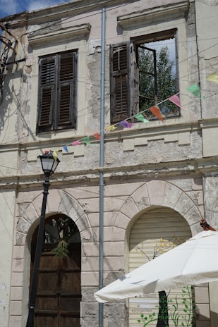 Small custom awning with scalloped edges shading a vintage shop entrance.