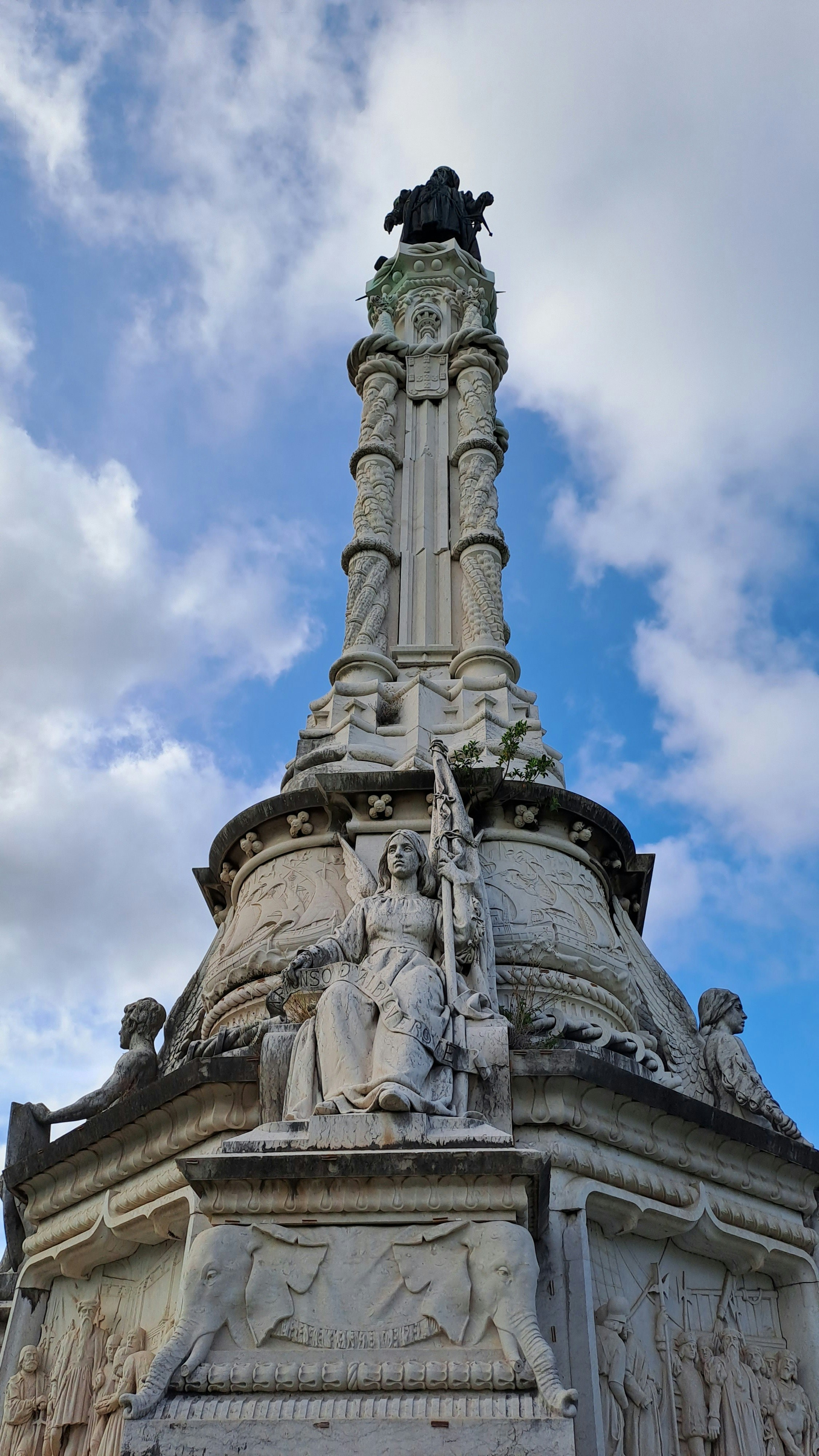 a statue on top of a building with a sky background