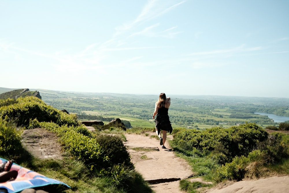 a person walking up a dirt path on a hill