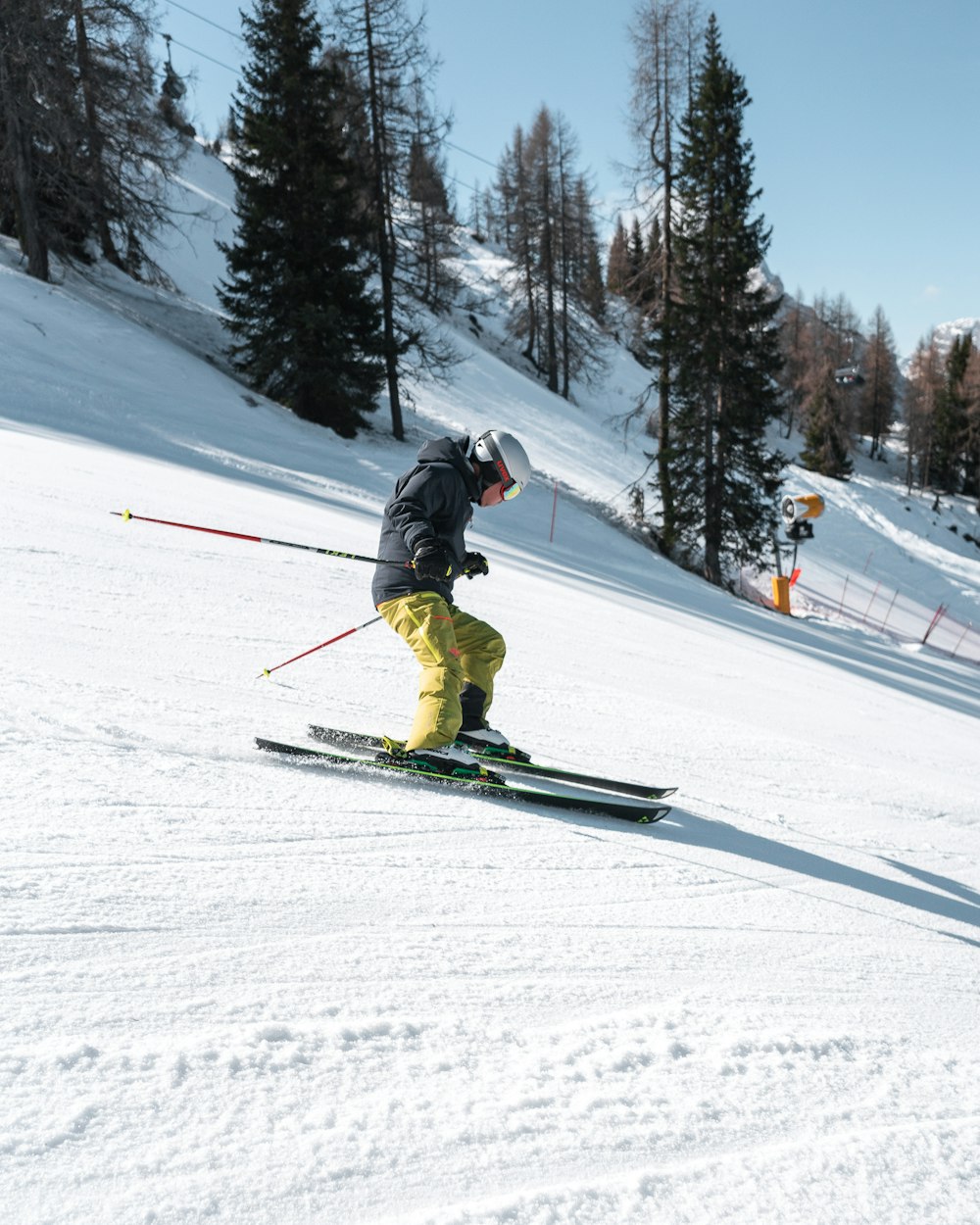 a man riding skis down a snow covered slope