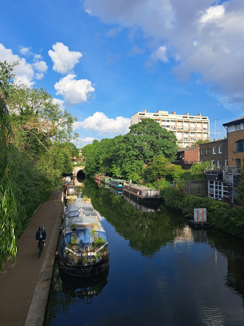 a narrow canal with a few boats on it