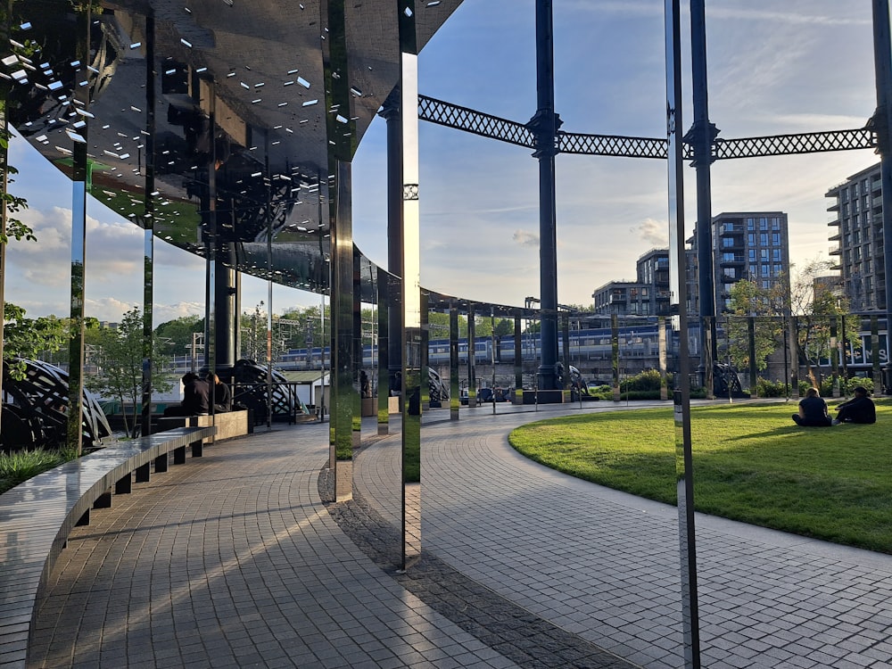 a walkway in a park with a clock tower in the background