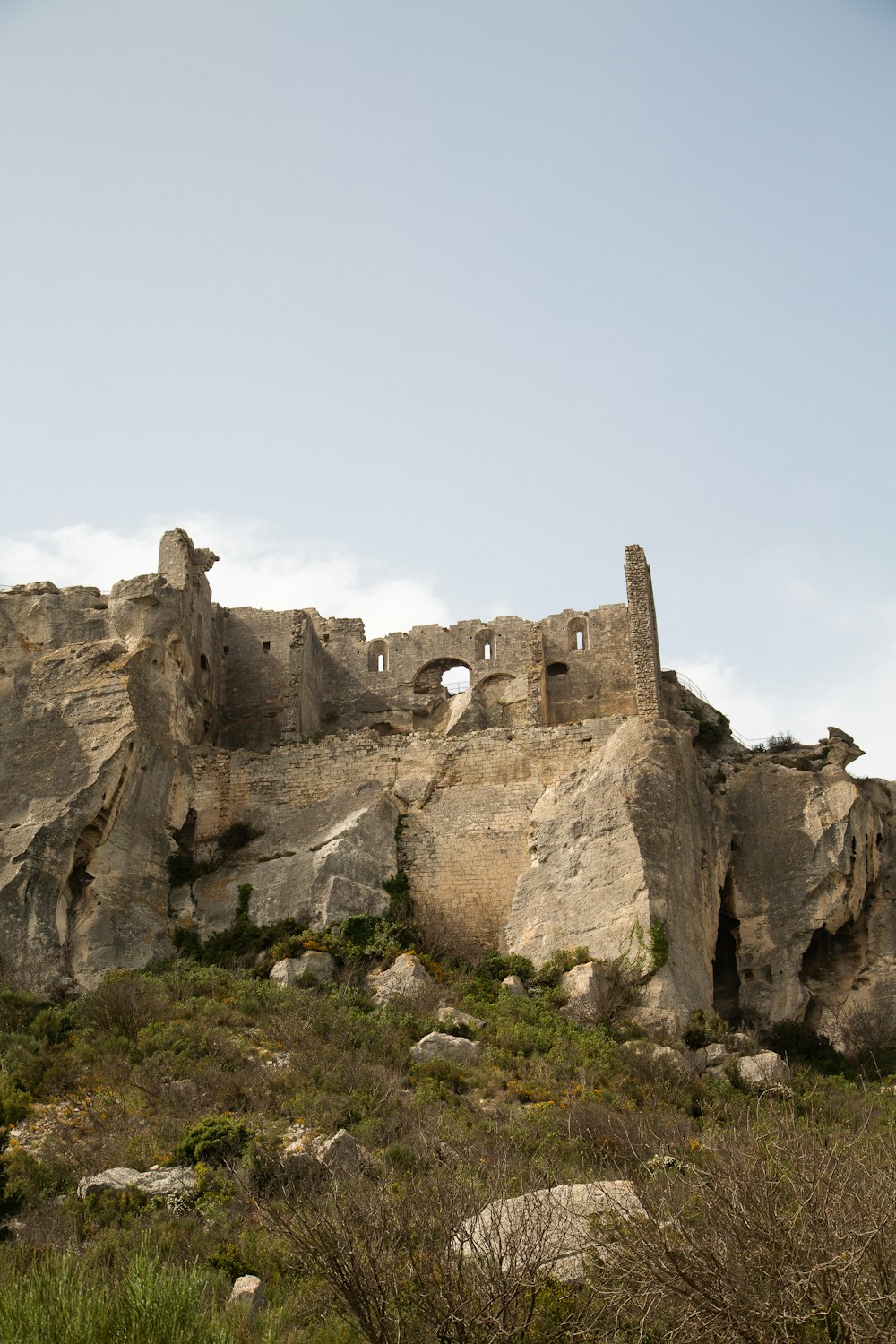 a rocky cliff with a building built into it