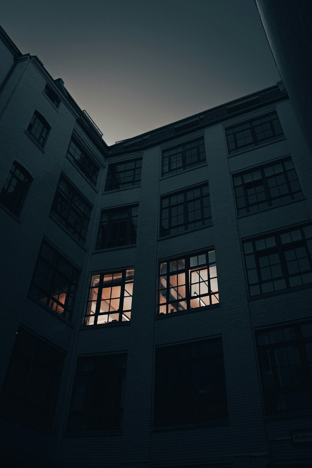 a tall building with windows lit up at night