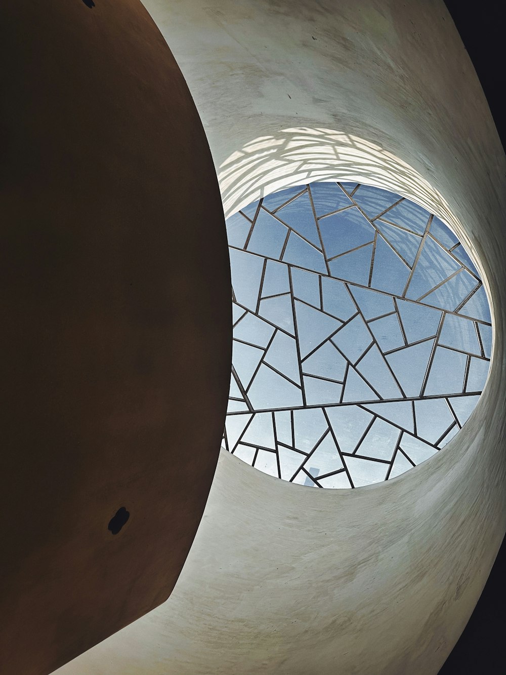 a round window with a skylight in the middle of it