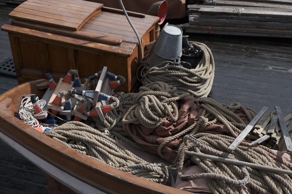 a wooden boat with ropes and other items in it