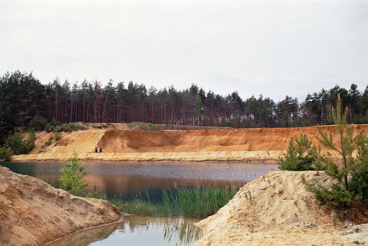 A lined water storage basin cut into bare earth