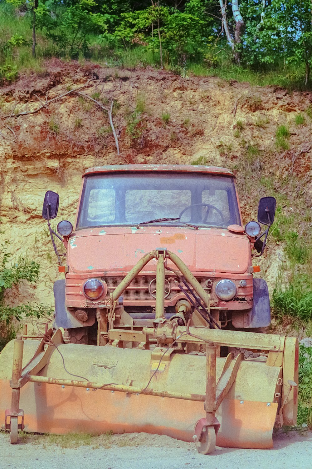 an old truck is parked on the side of the road