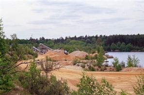 Aerial shot of the sand and gravel pit with trucks moving materials efficiently