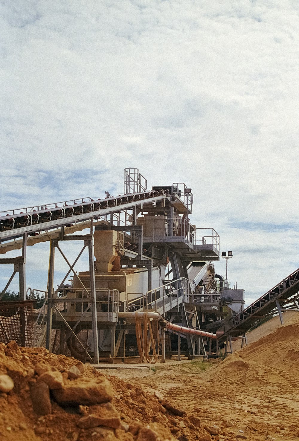 a large cement plant sitting on top of a dirt hill