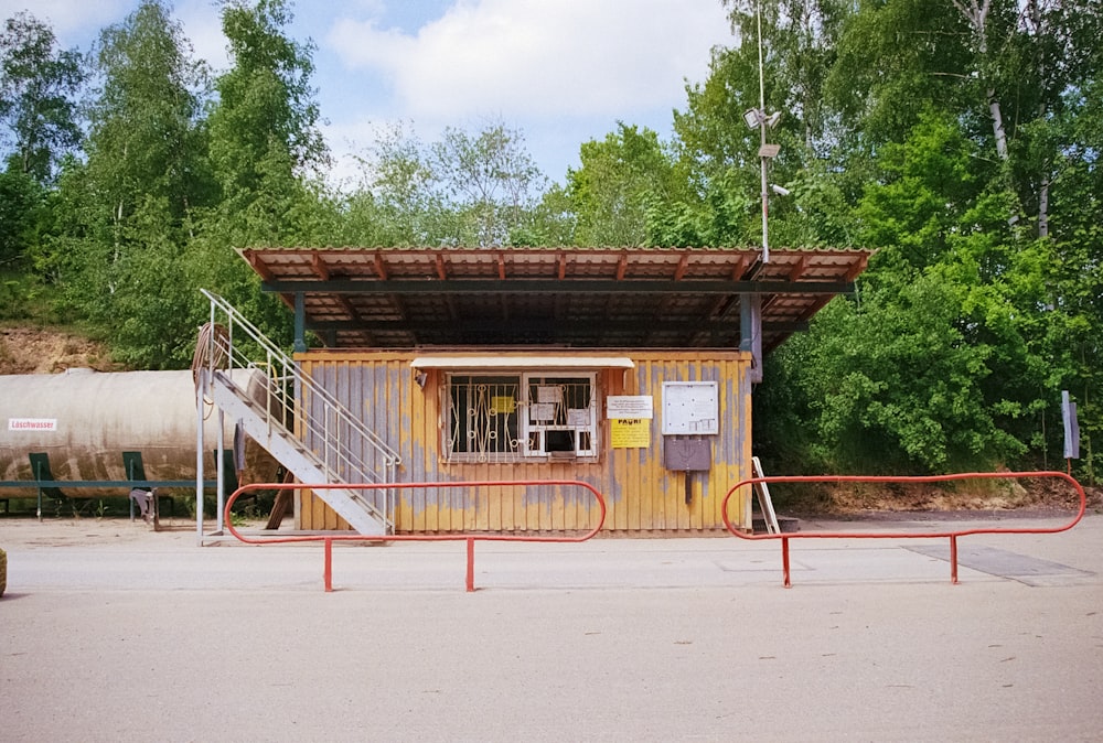 a small building with a metal fence around it