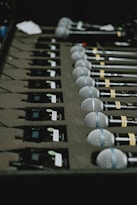 a bunch of microphones lined up on a table