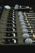 a bunch of microphones lined up on a table
