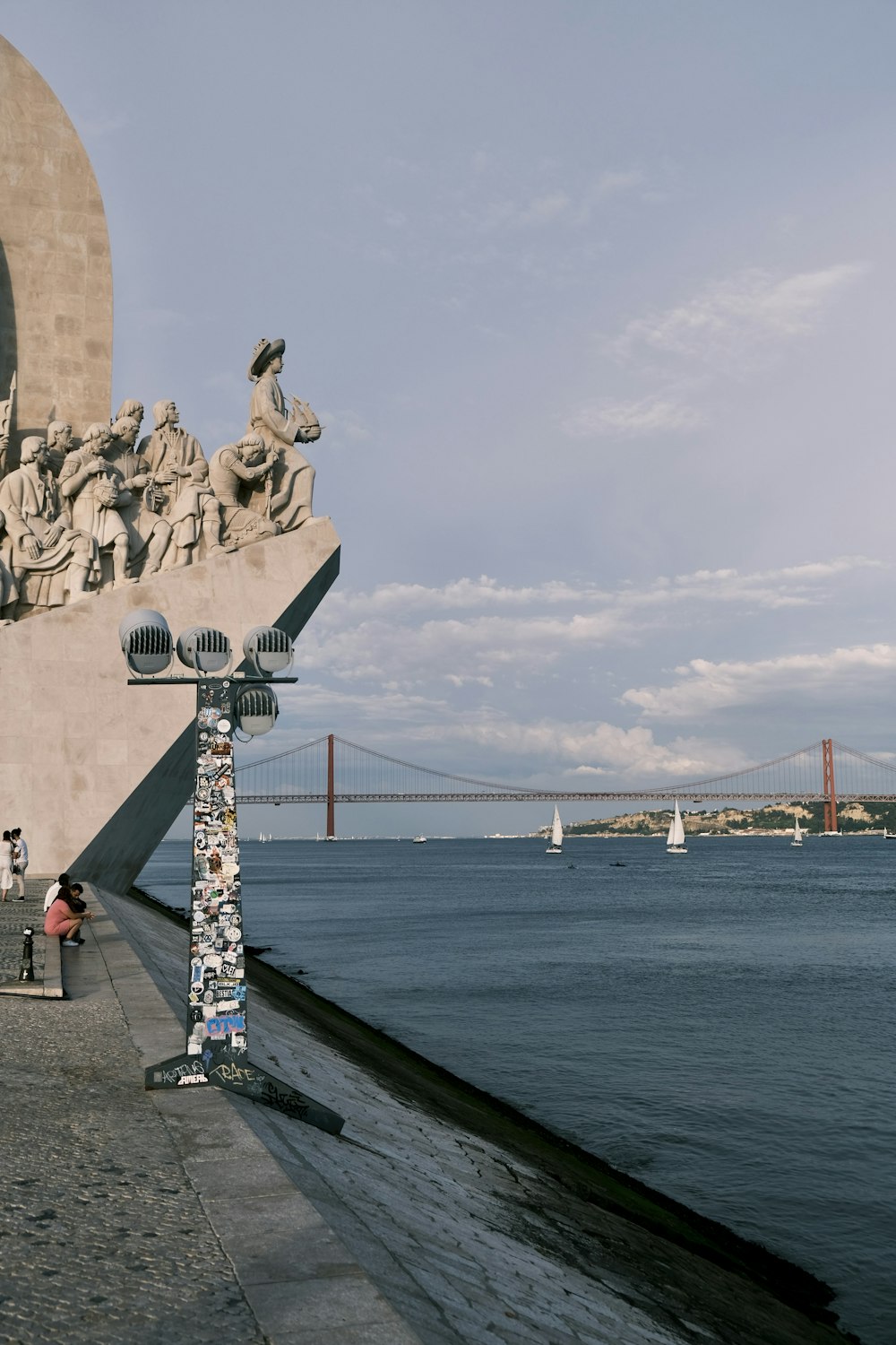 a group of people standing next to a body of water