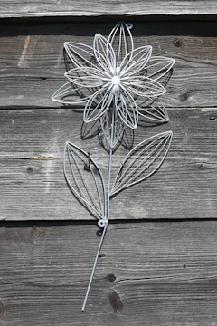 Decorative wooden and metal wall art inspired by natural forms.