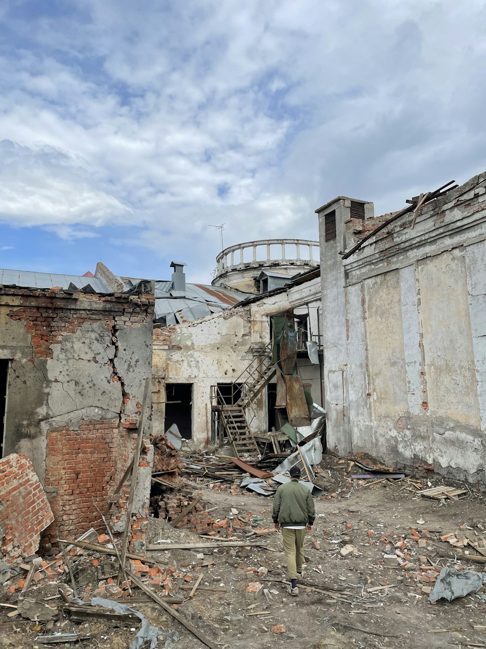 a man is walking through a destroyed building