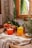 A refreshing glass of natural fruit juice garnished with fresh fruits on a wooden table.