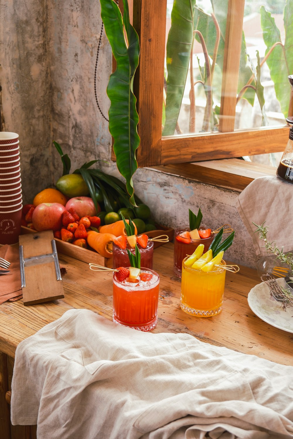 a wooden table topped with glasses filled with drinks