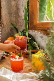 A lively classroom scene with participants learning to craft mocktails, surrounded by fresh fruits and tools.