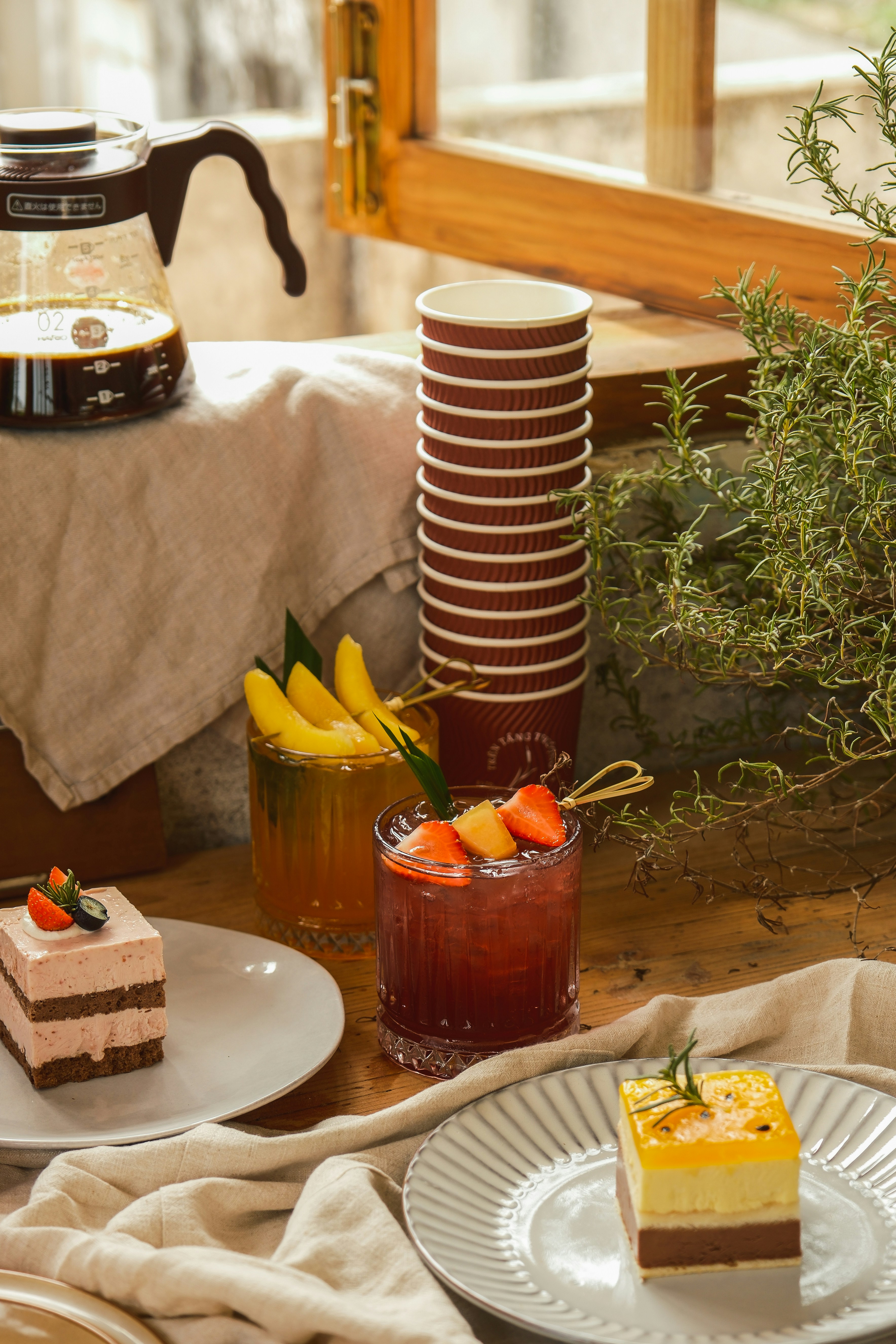 Shared table set with assorted food and beverages