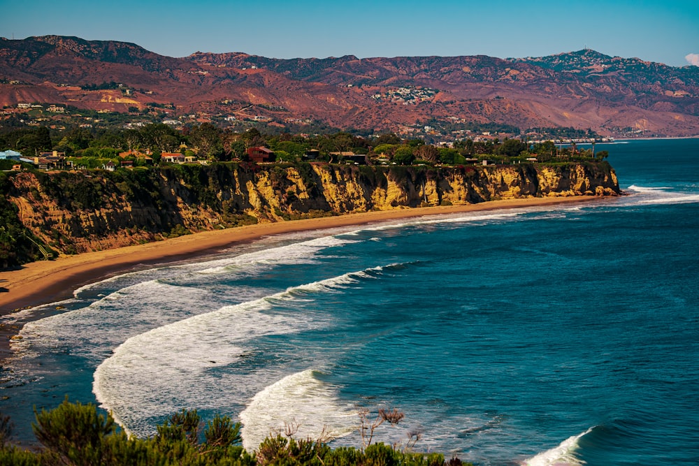 a view of a beach with a mountain in the background