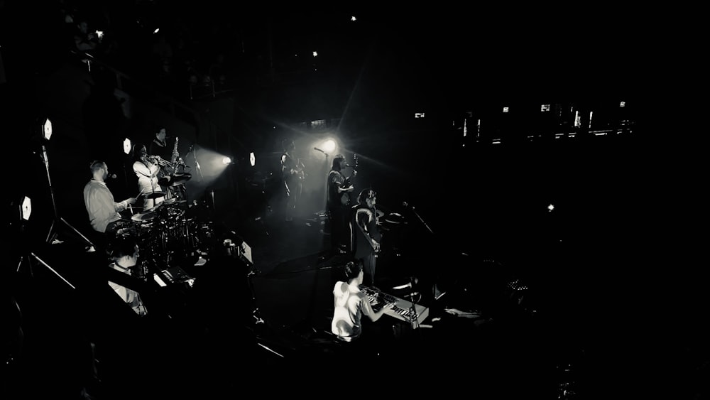 a black and white photo of a band on stage