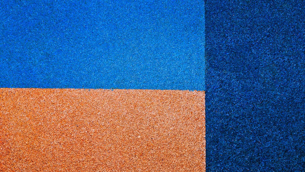 a close up of a blue and orange wall