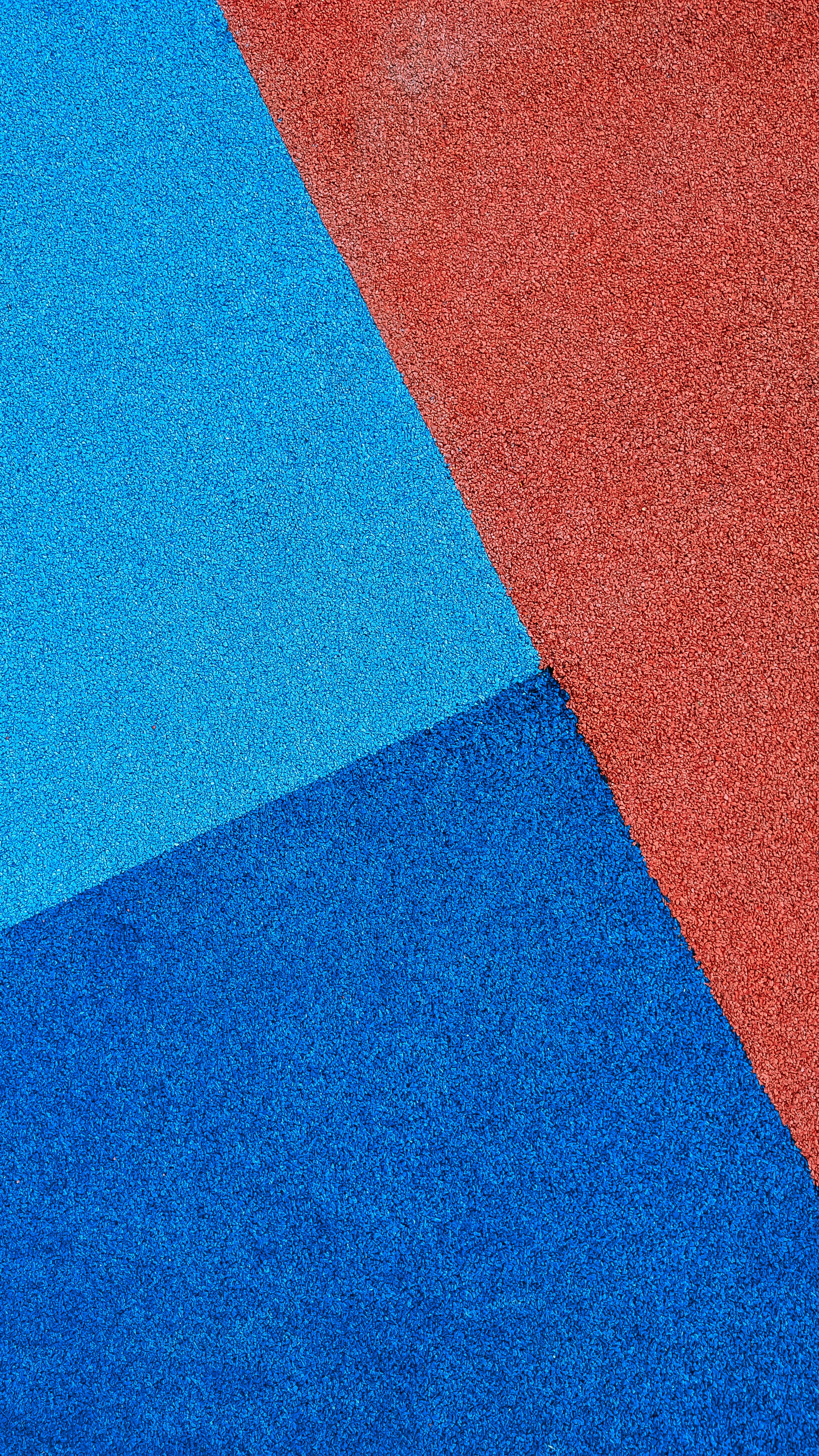 A close up of a red, blue, and orange carpet photo Free Floor Image