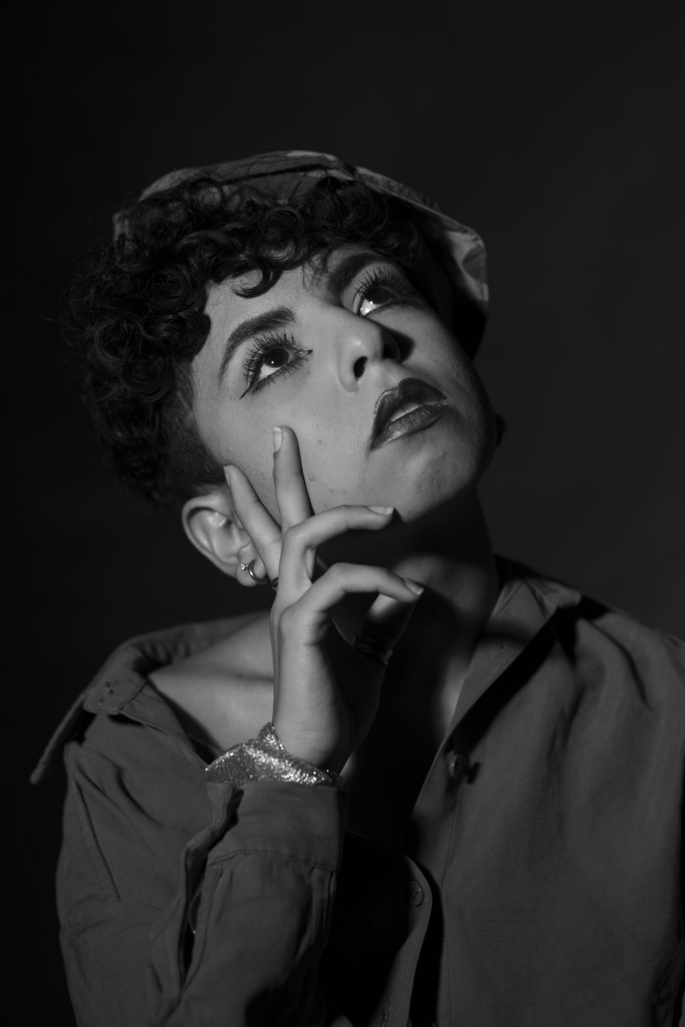 a black and white photo of a woman wearing a hat