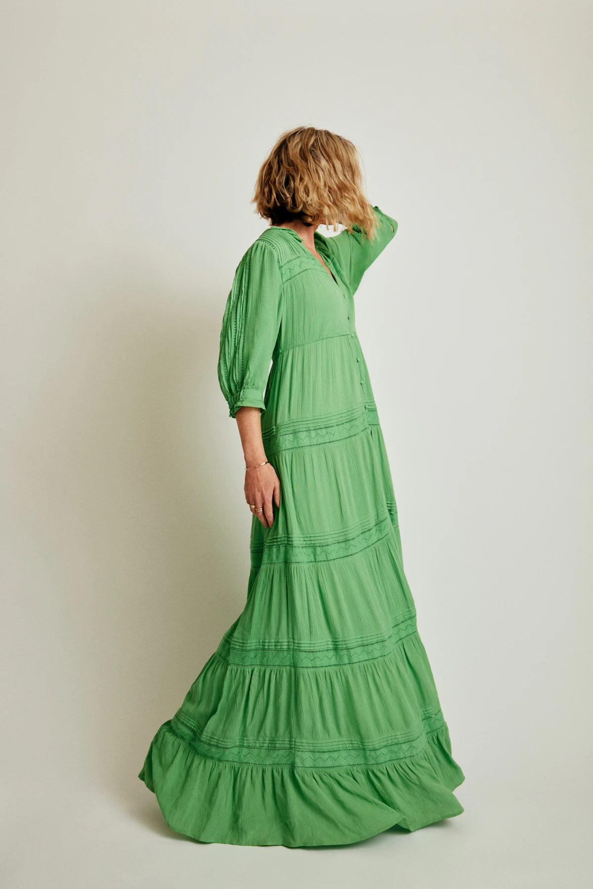 Woman in a long green tiered maxi dress