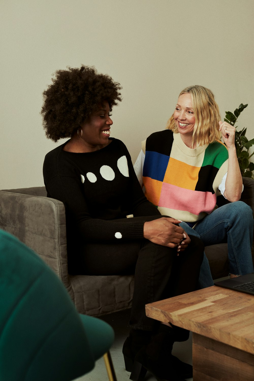 a couple of women sitting on top of a couch