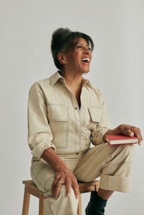 A happy author reviewing printed proofs of their new book with a smile.