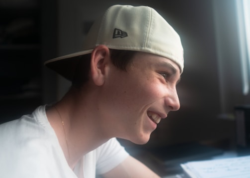 A relaxed adult student smiling while reviewing a printed thesis draft.