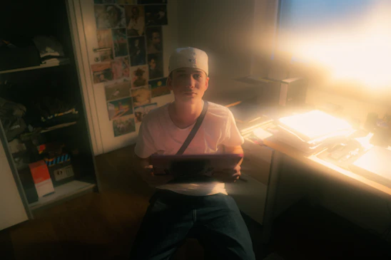 Portrait of the company founder in a cozy workspace filled with personal memorabilia.